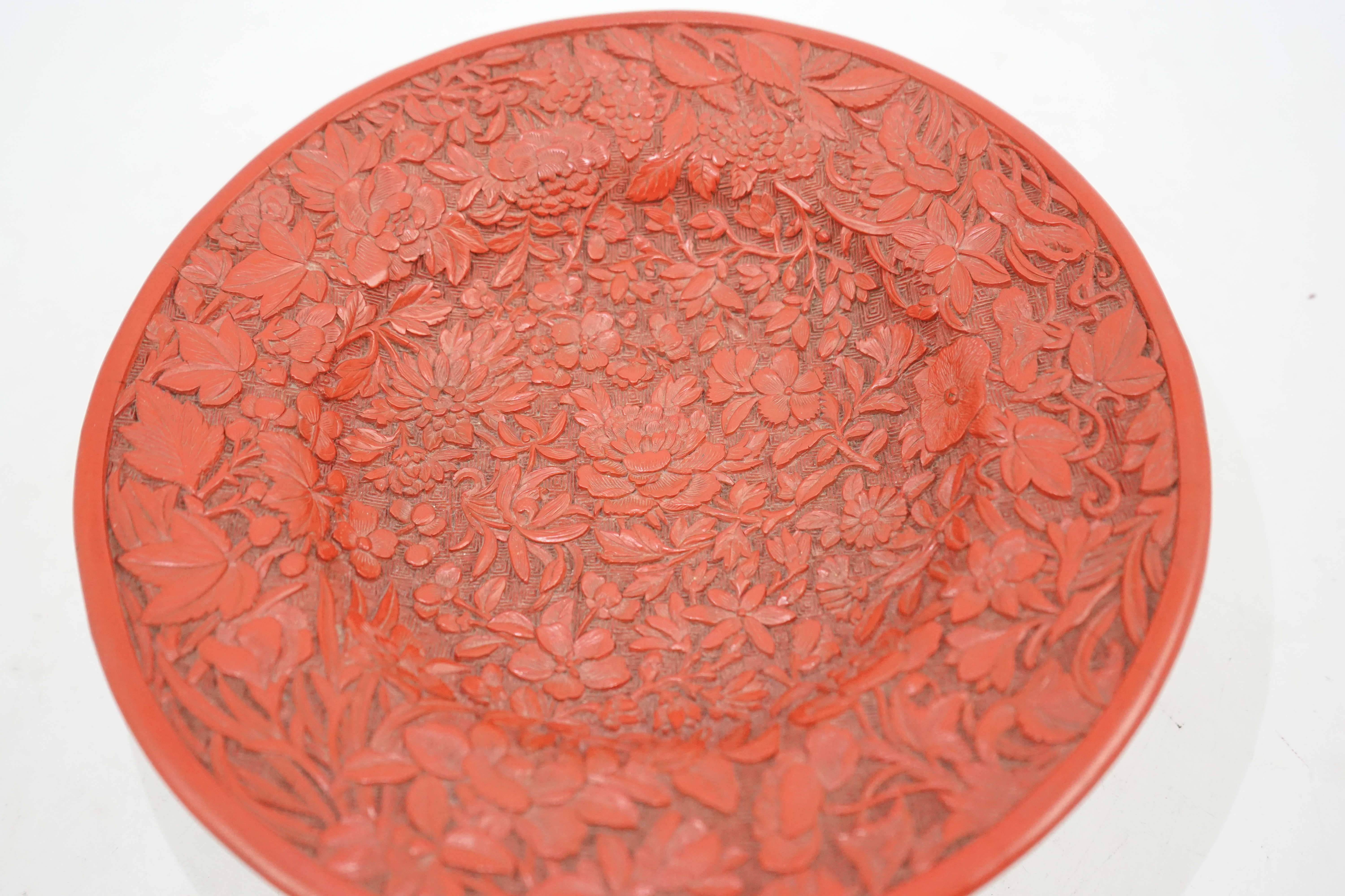 An unusual Chinese cinnabar lacquer ‘thousand flower’ footed dish, 18th/19th century